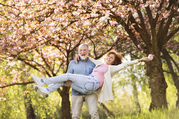 Senior couple in love outside in spring nature.