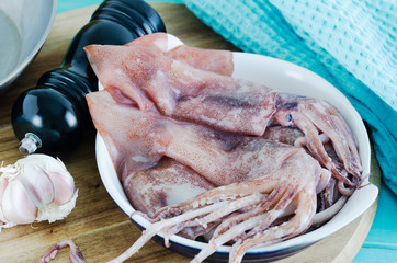 Squid on wooden table ready to cook.