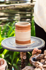 A clay pot on a pottery wheel, pottery craft