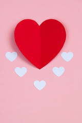 Fototapeta na wymiar Red paper heart on the pink background. Valentine's or Wedding's day postcard concept.