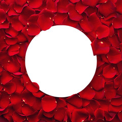 Red rose petals and round paper note