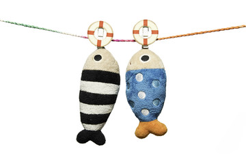 two pillows fish shape hanging on the rope isolated on white background