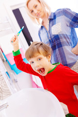 Little funny boy with a funny expression on his face in the bathroom