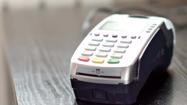Customer paying with NFC technology by mobile phone on terminal. 4K UltraHD video