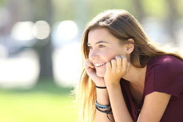 Happy teenager looking forward in a park