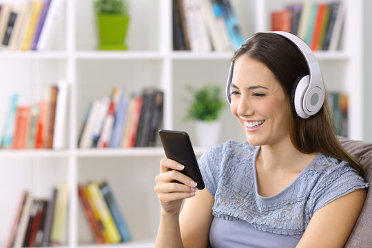 Girl listening to music on line on a smart phone