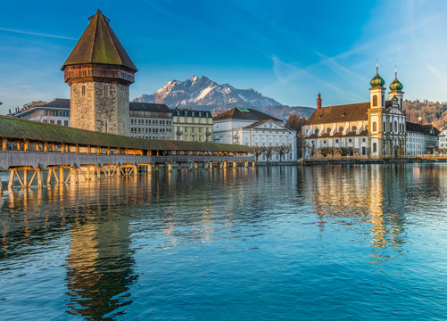 The Kapellbrücke (Chapel Bridge), a covered wooden footbridge spanning diagonally across the Reuss in the city of Lucerne in central Switzerland.
