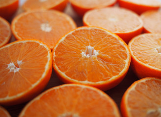 Mandarins, sliced for juice.Fruits of mandarin , cut, on wooden background.