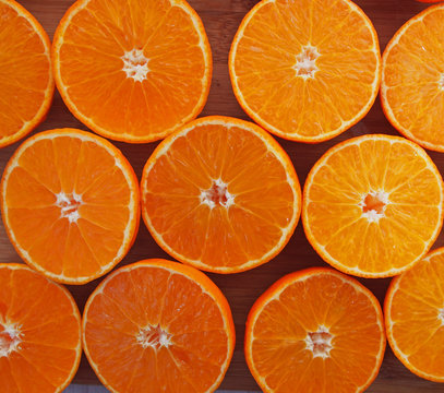 Mandarins, sliced for juice.Fruits of mandarin , cut, on wooden background.