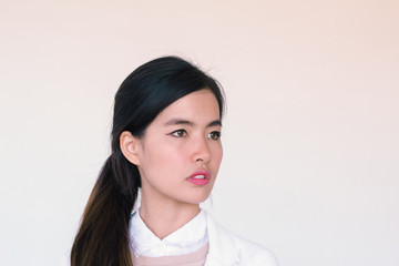 Young Asian businesswoman wearing white suit and looking away