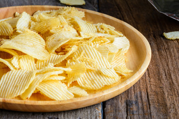 Snacks in a wooden dish on a table