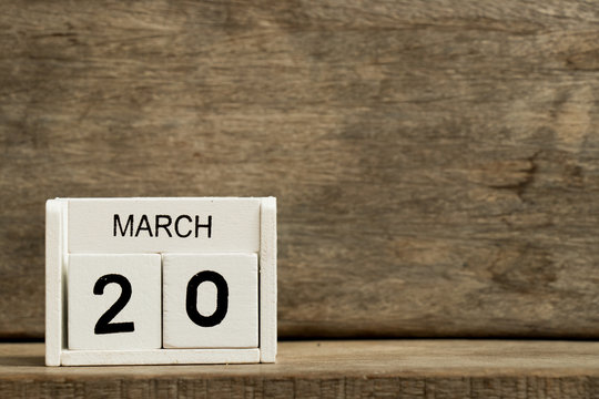 White block calendar present date 20 and month March on wood background