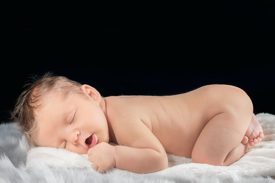 Portrait of a newborn on a black background