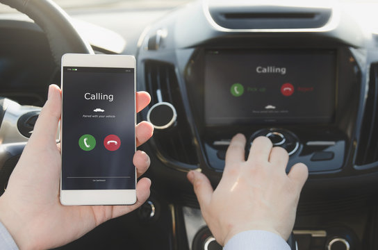 Man using phone calling system in car