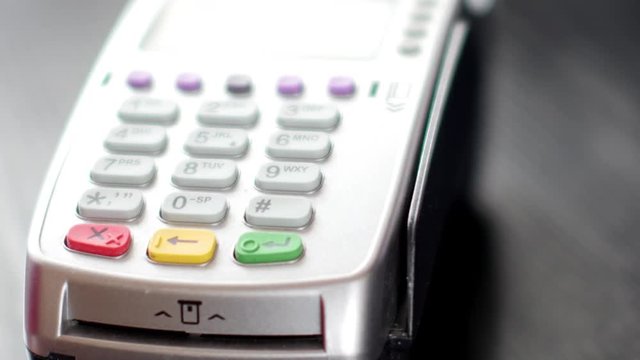 Customer paying with NFC technology by mobile phone on terminal. 4K UltraHD video