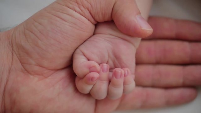 Father and baby hand