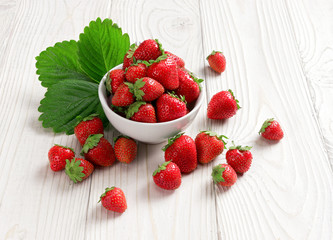 Healthy strawberries in bowl on wooden table. Close up, high resolution product. Harvest Concept