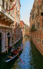 Fototapeta na wymiar Venice, Italy - August 14, 2017: Venice canal with boats and classic buildings.