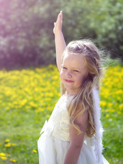 Girl with angel wings on the background of nature.