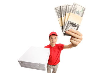 Teenage pizza delivery boy with bundles of money