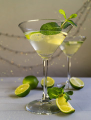 Drink in Martini glass on a gray background.