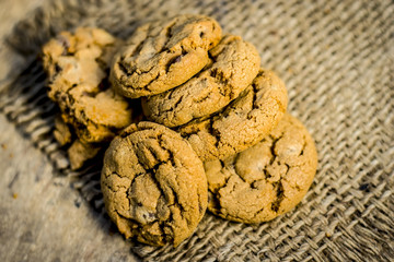 Homemade freshly baked chocolate chip cookies on gunny background.
