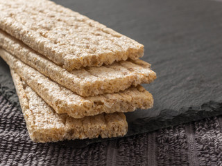 Crispbreads whole grain oat on a black background. Healthy eating. Healthy food.