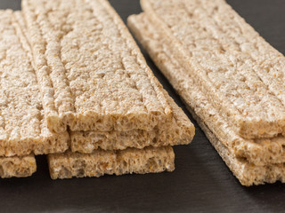 Crispbreads whole grain oat on a black background. Healthy eating. Healthy food.