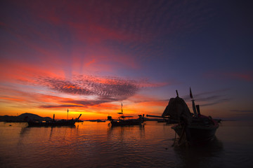 twilight beautiful sky at rawai beach in morning with Andaman boat.