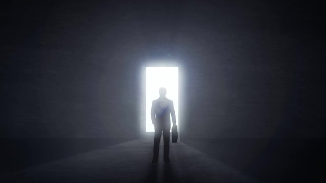 Man standing at opening glowing door in darkness, light rays coming trough. Challenge concept.