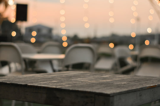Close up wood table in the restaurant
with bokeh background.
