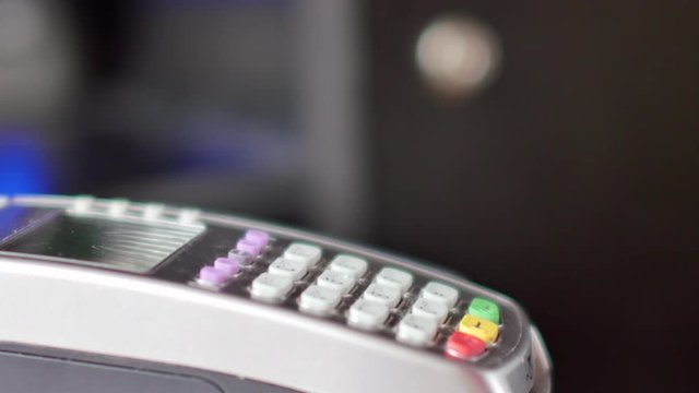 Customer paying with NFC technology by mobile phone on terminal. 4K UltraHD video