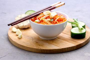 Organic Spicy Carrot Salad with Cucumber and Garlic Vegan Organic Food Concept Wooden Tray
