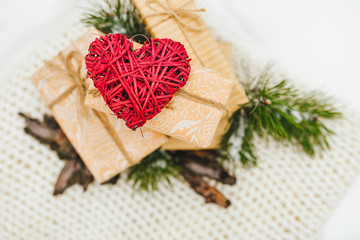 The Valentines day concept. Valentines gifts. Hearts made of wool, watches, cinnamon lie on a woolen blanket on a snow background. Winter theme. top view.