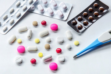 Top view of the pills on the white background, Pack of tablet drug and capsule pills on the floor, Pile of the drug and pills on the white background.