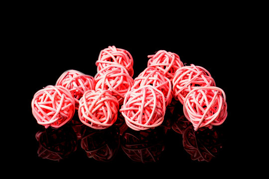 Pink rattan light balls on black background. Creative decoration concept for Christmas celebration and Holiday.