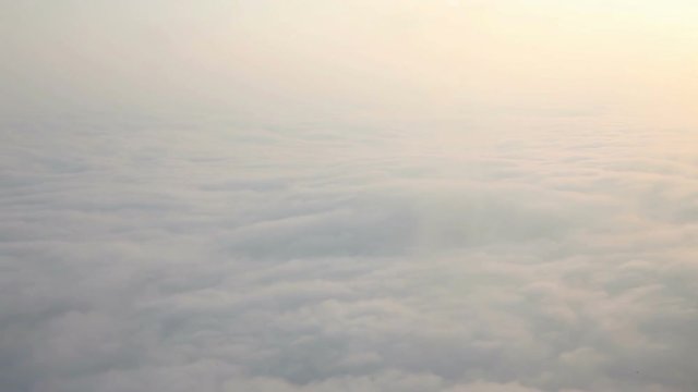 Aerial view above the clouds,side shot from a aircraft flying over clouds. 