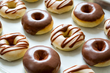 Sweet donuts with chocolate coating. Flat lay. Top view