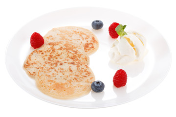 Serving pancakes with ice cream and fresh berries on the plate. Isolated on white background.