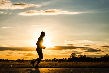 Silhouette man running at sunset