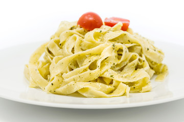 Pasta with pesto sauce and nuts on a the table