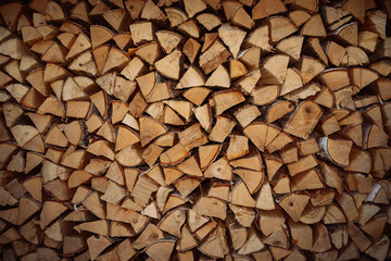 Woodpile end of tightly packed chopped birch and pine logs.
