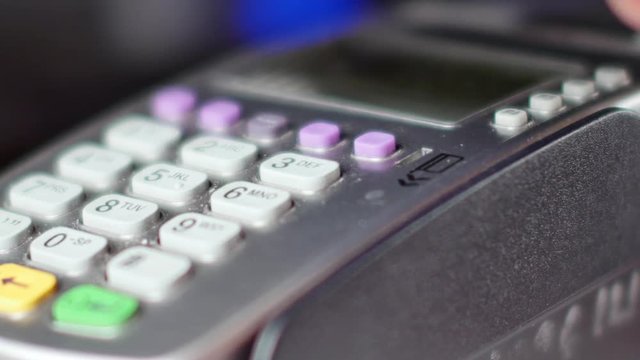 Customer paying with NFC technology by mobile phone on terminal. 4K UltraHD video