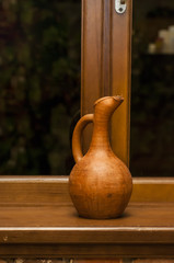 ceramic jug wine is on the windowsill