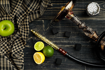 Dismantled parts of hookah on a wooden background with lime and 