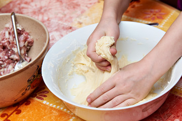 Obraz na płótnie Canvas Womens hands with dough