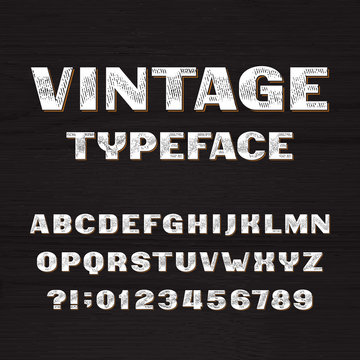 Vintage typeface. Retro alphabet font. Type letters and numbers on a rough wooden background. Vector font for your headers or any typography design.