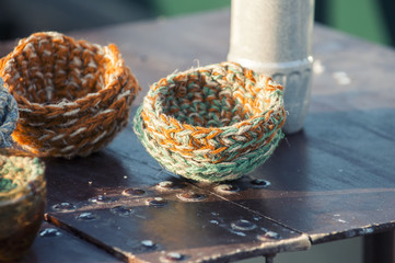 Several artificial nests for birds made from wool.