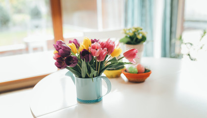 Fototapeta na wymiar Spring easter tulips in bucket on white table