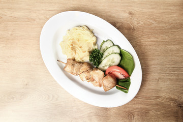 kebabs,garnish and sliced vegetables on plate